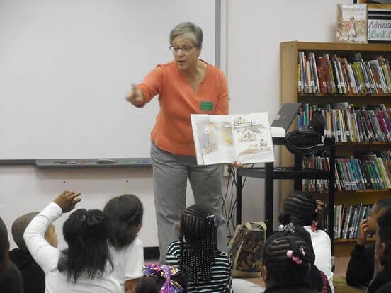 Author presenting to a class in a library